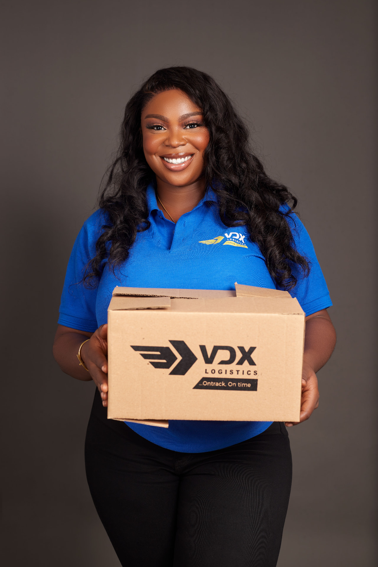 VDX team member holding a VDX branded delivery box